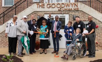 Image of BHC staff and friends cutting a ribbon at grand opening of The Goodwyn at Union Hill