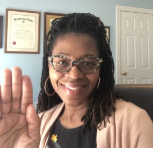 Monique Johnson, right hand raised, international womens day